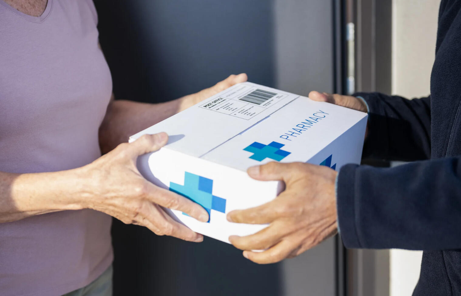A woman taking prescription delivery from her door